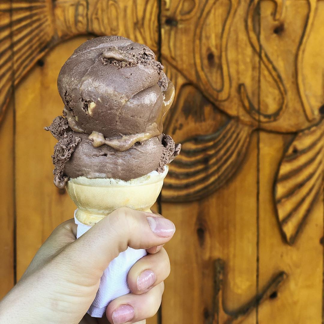 A towering waffle cone with multiple scoops of hard ice cream from Big Moose