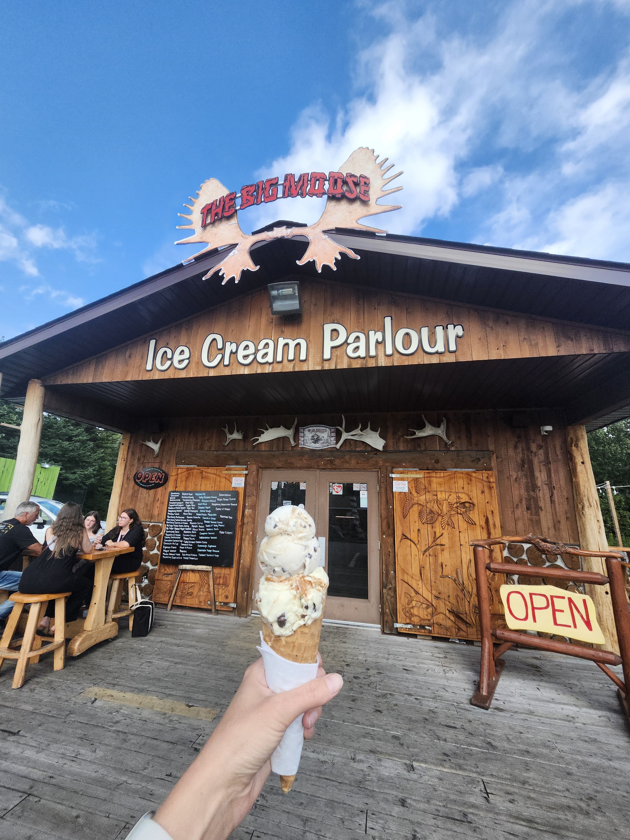 A tall waffle cone piled with scoops of ice cream